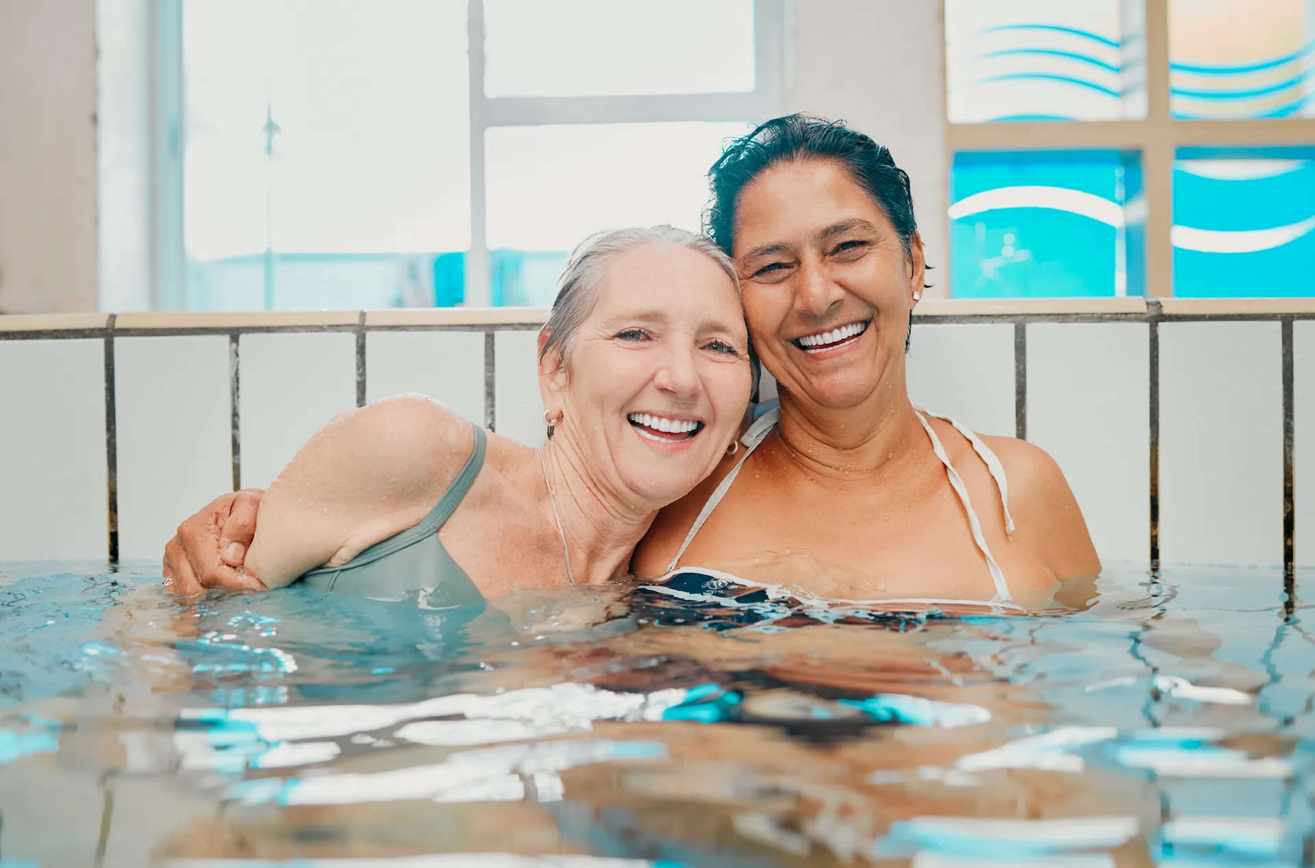 Zwei Frauen lachend im Schwimmbecken